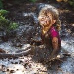 little girl playing in mud